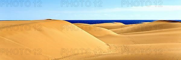 The dunes of Playa Del Ingles with a view of the Atlantic Ocean. San Bartolome de Tirajana, Gran Canaria