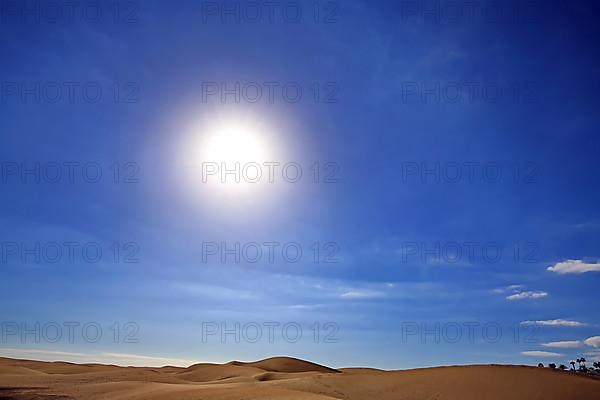 The dunes of Playa Del Ingles with a view of the sun. San Bartolome de Tirajana, Gran Canaria