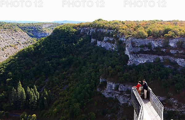 People standing on a lookout pulpit above the valley,