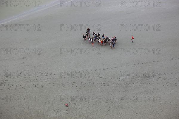 View from the monastery mountain Mont Saint-Michel to the walkers in the Wadden Sea, Basse-Normandie