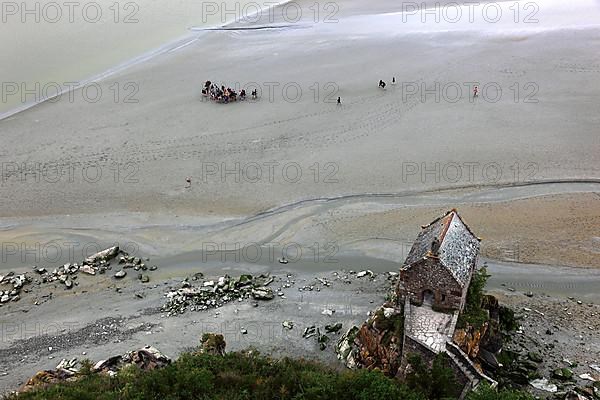 View from the monastery hill of Mont Saint-Michel towards the walkers on the mudflats and the Chapelle Saint-Aubert du Mont-Saint-Michel, Basse-Normandie