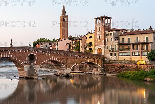 Arched bridge Ponte Pietra, spans the river Adige