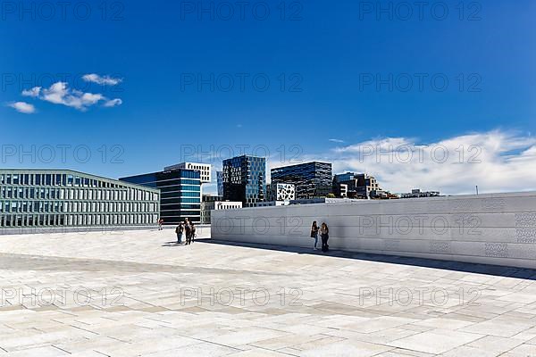 Pedestrians on the white roof of the opera house, modern architecture