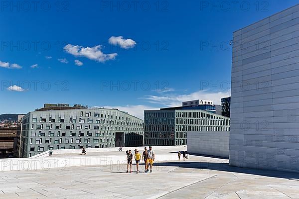 Pedestrians on the white roof of the opera house, modern architecture