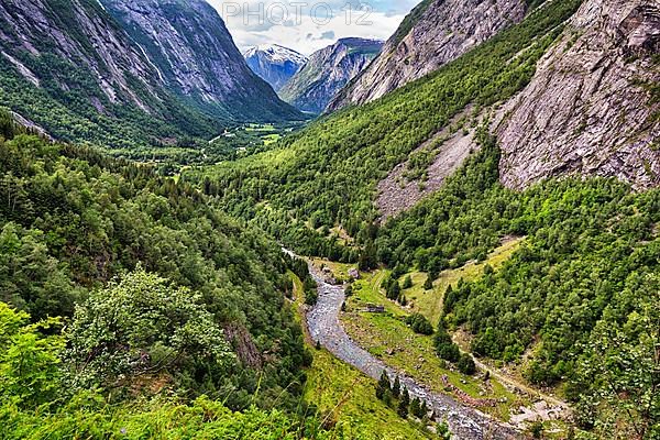 View from above of the forested valley Eikesdalen, high mountains and the river Aura