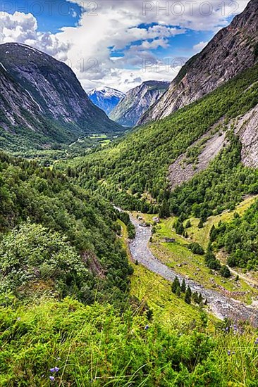 View from above of the forested valley Eikesdalen, high mountains and the river Aura