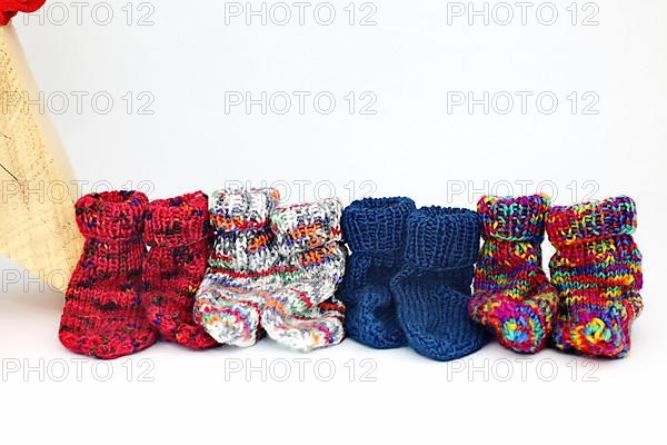 Christmas wooden star with a red bow isolated against a white background, Self-knitted socks on the side