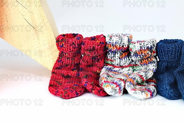 Christmas wooden star with a red bow isolated against a white background, Self-knitted socks on the side