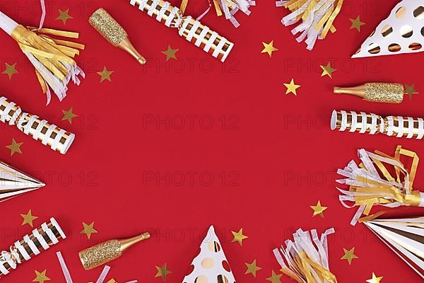 Golden party objects like hats, confetti and gifts forming frame around red background