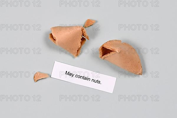Food allergy concept. Fortune cookie with text 'may contain nuts',