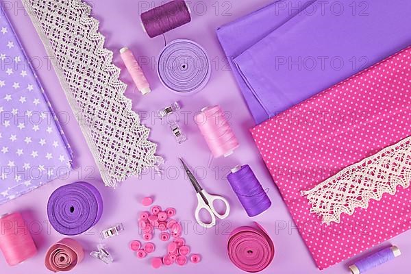 Sewing flat lay with various tools like fabric, scissors