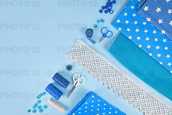 Sewing flat lay with various tools like fabric, scissors