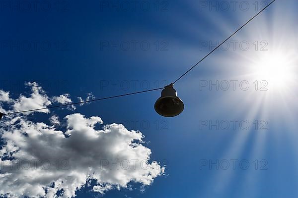 Single discarded bell hanging on steel cable, sound body