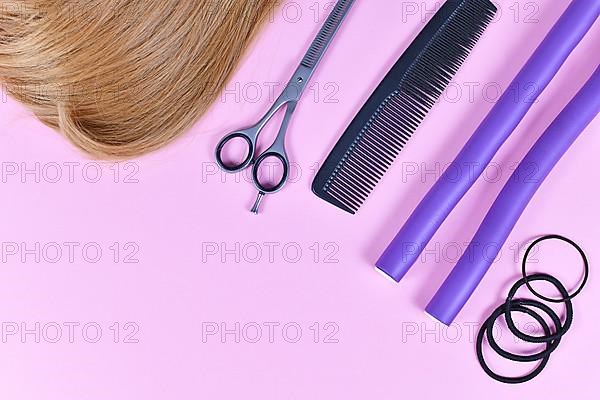 Hair styling concept with dark blond hair, elastic hair ties