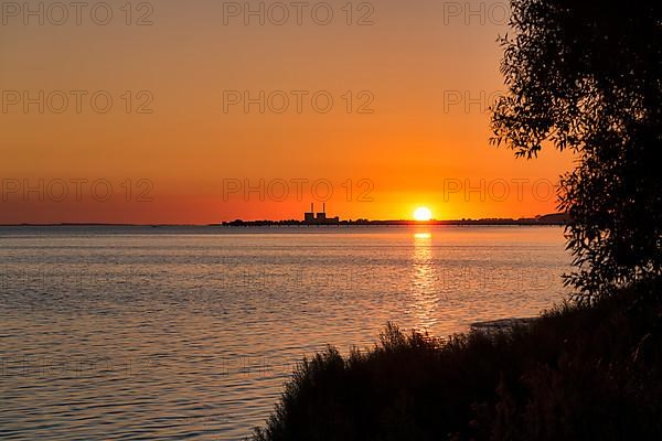 Sunset at Lomma Bay, chimneys of the decommissioned Barsebaeck nuclear power plant on the horizon