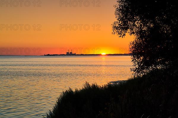 Sunset at Lomma Bay, chimneys of the decommissioned Barsebaeck nuclear power plant on the horizon