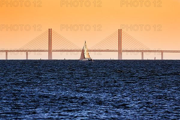 Sailboat in front of the Oeresund Bridge, Oresundsbroen between Malmoe and Copenhagen