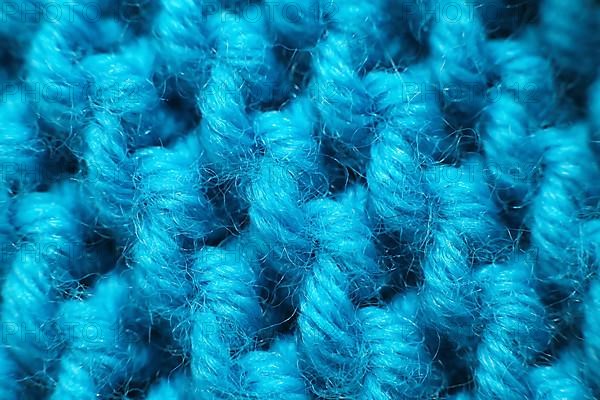 Knitted wool blanket in the colour magenta. Macro,