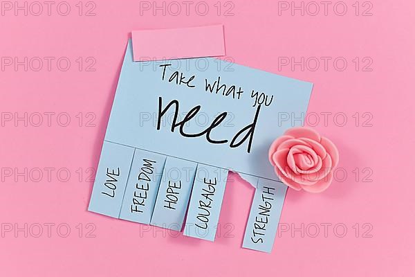 Blue tear-off stub note with text Take what you need and words Love, Freedom