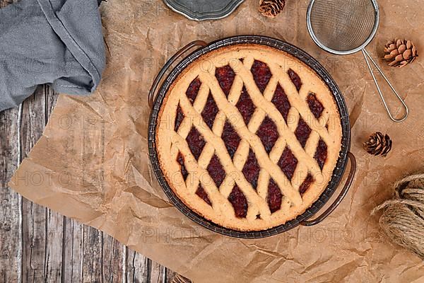 Top view of homemade pie called 'Linzer Torte', a traditional Austrian shortcake pastry topped with fruit preserves and ground nuts with lattice design