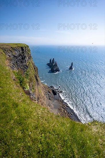 Cliff, rock Reynisdrangar in the water