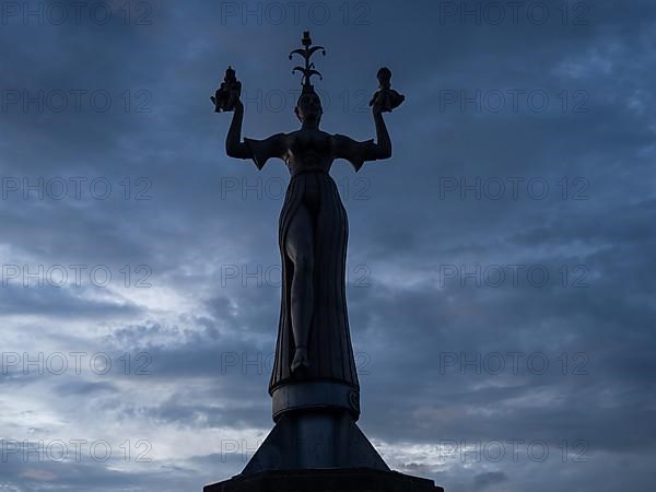 Statue of Imperia at the harbour entrance of Constance in the morning light in front of sunrise, Old Town