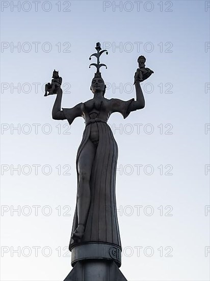 Statue of Imperia at the harbour entrance of Constance in the morning light in front of sunrise, Old Town