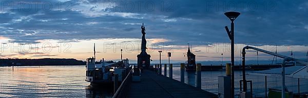 Statue of Imperia at the harbour entrance of Constance in the morning light in front of sunrise, Old Town