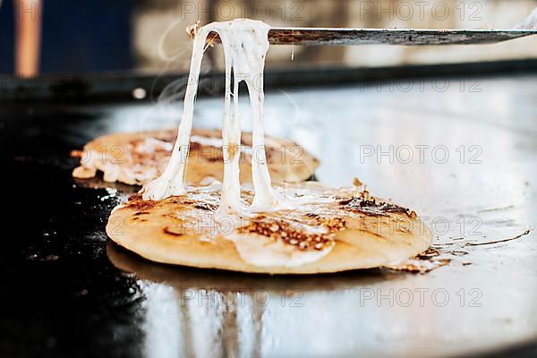 Traditional grilled cheese pupusas, Close up of traditional handmade pupusas on grill. Traditional Nicaraguan Pupusas with melted cheese on grill