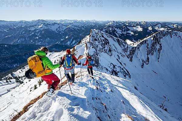 Ski tourers in winter on the snow-covered Rotwand, mountains in winter