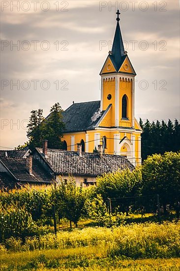 Fields and village panorama with church in a landscape, Somogyvamos