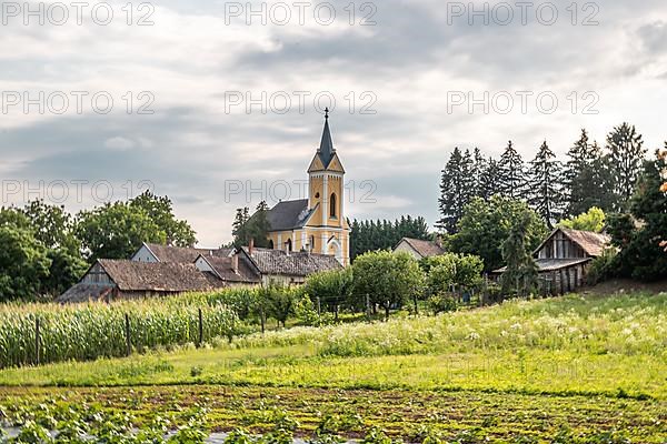 Fields and village panorama with church in a landscape, Somogyvamos