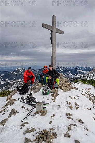 Three ski tourers at the summit of the Jaegerkamp in winter, Bavaria