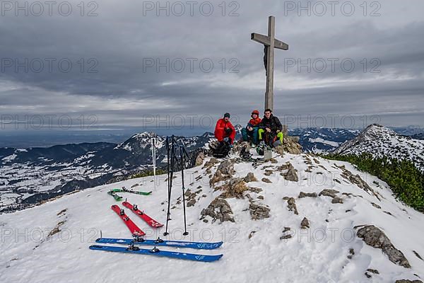 Three ski tourers at the summit of the Jaegerkamp in winter, Bavaria