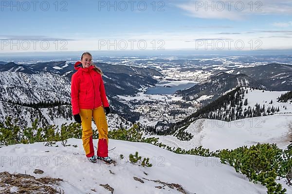 View of Schliersee, ski tourer at the summit of Jaegerkamp in winter
