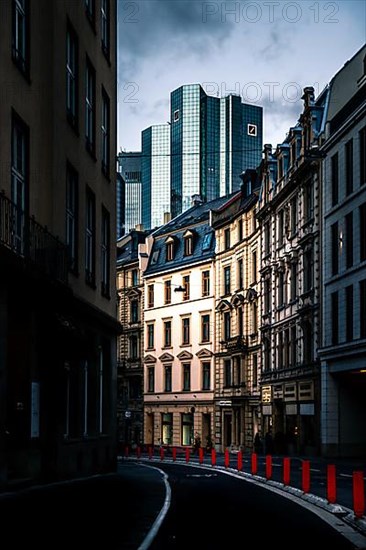 Street with old houses in Frankfurt in the background a modern glass building of the Deutschebank and the skyline, Frankfurt