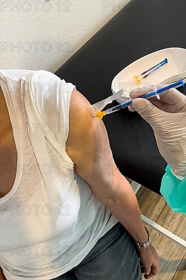 Elderly woman receives injection with medical syringe fourth vaccination booster vaccination against coronavirus disease Covid-19 C19 corona virus Corona virus, Germany