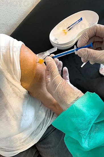 Elderly woman receives injection with medical syringe fourth vaccination booster vaccination against coronavirus disease Covid-19 C19 corona virus Corona virus, Germany