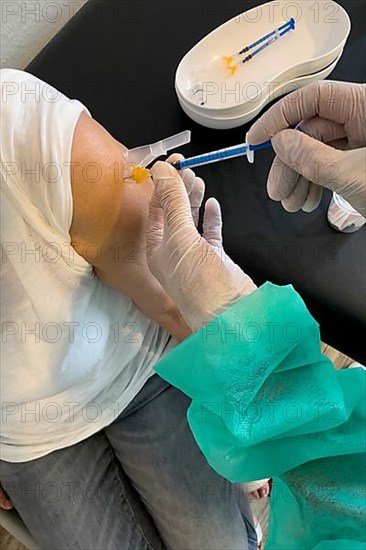 Elderly woman receives injection with medical syringe fourth vaccination booster vaccination against coronavirus disease Covid-19 C19 corona virus Corona virus, Germany