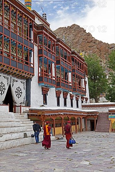 Two monks walking across the monastery courtyard, Hemis Gompa