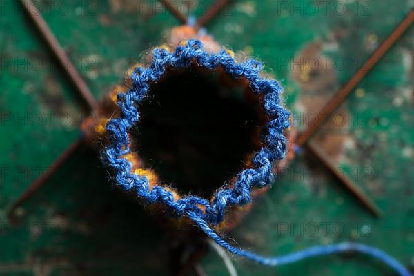 Handwork, knitted sock with knitting needles and wool