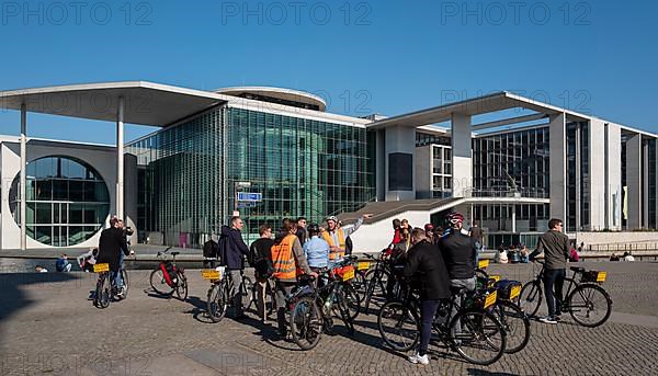 Tourists with bicycle and guide in the Berlin government district, Berlin