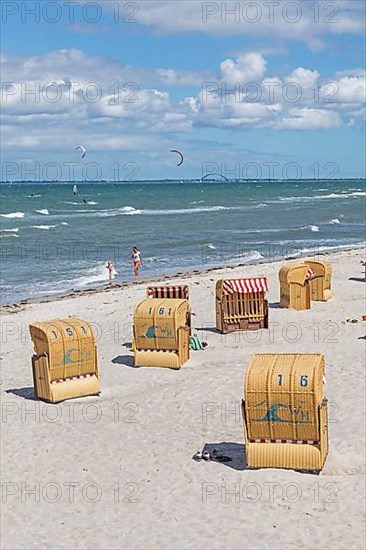 Beach chairs, kite surfers