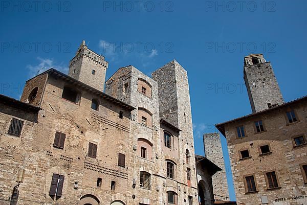 Gender towers and medieval buildings against a blue sky, San Gimignano