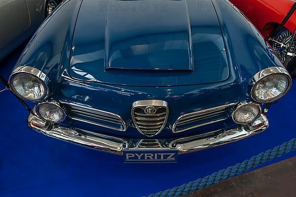 Front of classic Alfa Romeo 2600 Spider with radiator grill Scudetto and air scoop hat on the bonnet, two pairs of round headlights