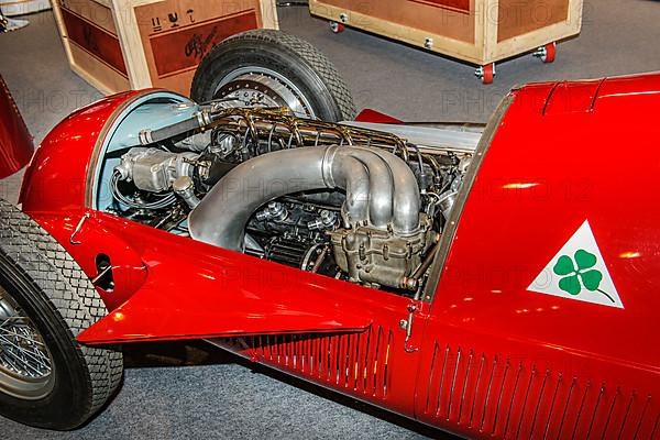 View into engine compartment of historic Italian racing car Alfa Romeo GP Tipo 158 Alfetta first Formal 1 winner 1950 50s, right logo Quadrifoglio four-leaf clover number plate for high-performance Alfa Romeo sports cars