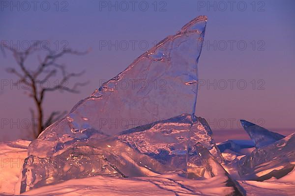 Clear ice wind blasted pressure ridge at sunset on Lake Manitoba near Limestone Point Manitoba Canada,