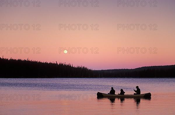 People fishing in canoe with full moon rising, Olallie Lake