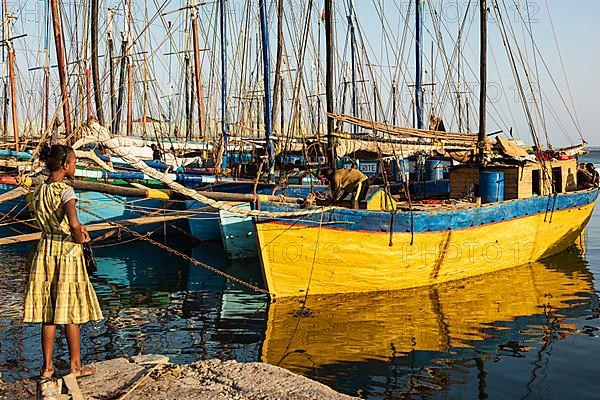 Girl in yellow dress, fishing boats