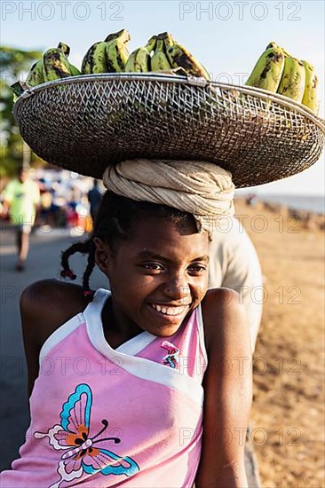 Girl with head load, basket with bananas